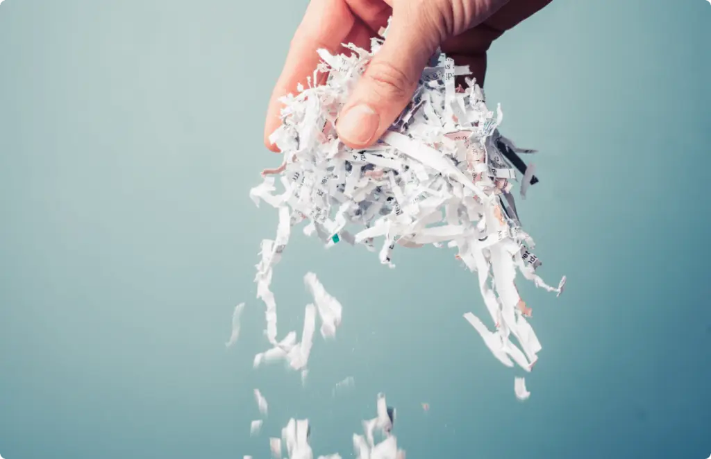 shredding-img Hand lifting shredded paper