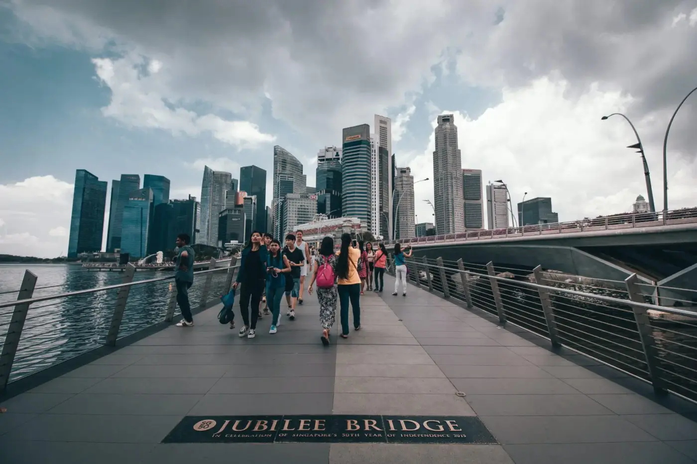 People walking on a bridge People walking on a bridge